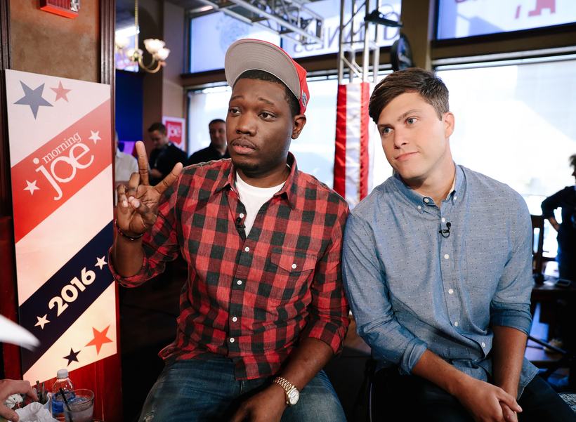 Michael Che and Colin Jost seated on the 2016 Morning Joe set.