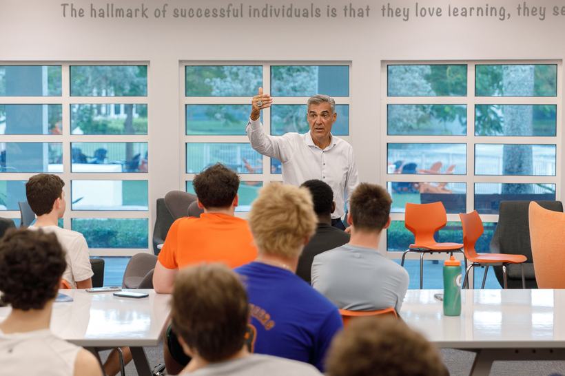 Coach Jay Wright speaking to a room of students at The Benjamin School.