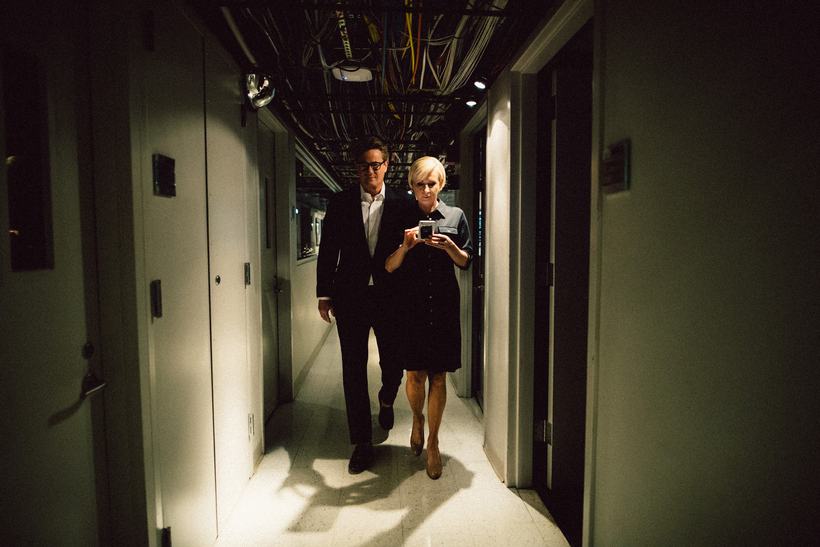 Joe Scarborough and Mika Brzezinski walking down a dim studio corridor.